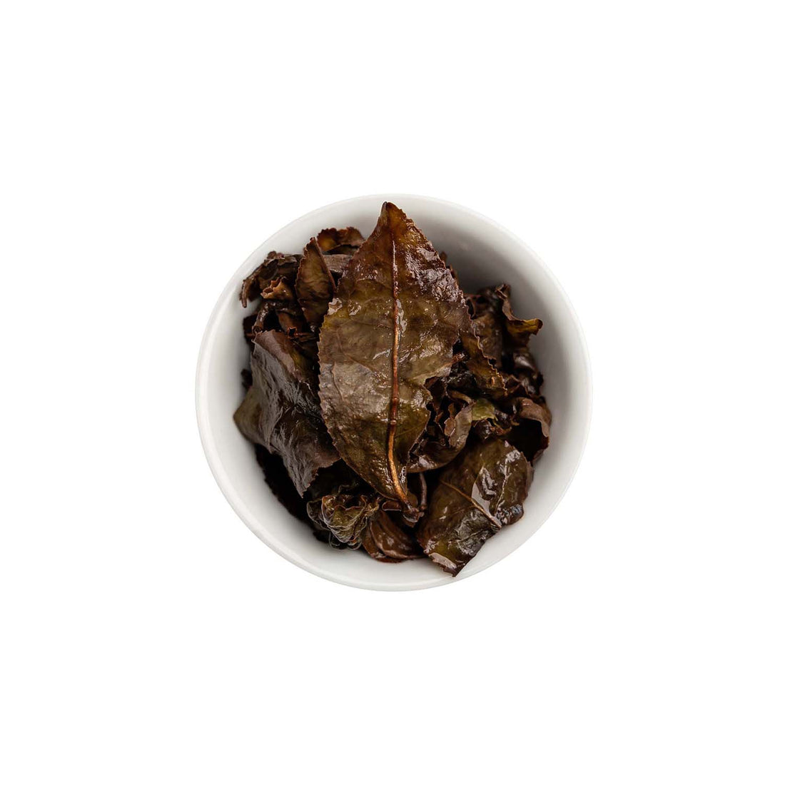 Ein ansprechendes Foto von den losen, aufgebrühten Blättern unseres Oolong Tees Bright Rose in einer Tasse.